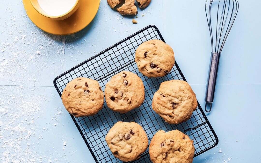 cookies on black grill beside yellow ceramic cup