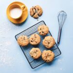 cookies on black grill beside yellow ceramic cup